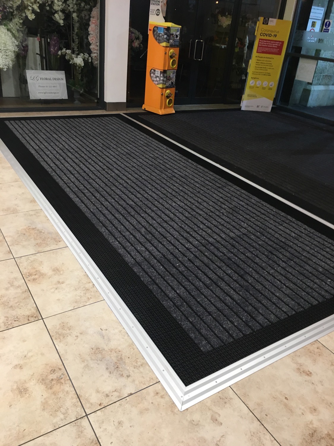 Surface mounted matting extension for busy shopping centre